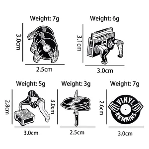 Five-piece set of black and white music enamel pins featuring vinyl records and radios