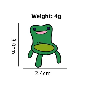Detail view of cartoon green frog chair brooch with 3.0cm height and 2.4cm width dimensions