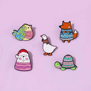 Detailed close-up of colorful animal enamel pins set with seal, fox, duck and turtle shapes