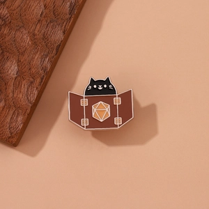 Cartoon black cat enamel pin with D20 dice screen for RPG fans on beige background