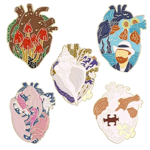 Set of creative heart-shaped enamel pins featuring colorful nature and art patterns