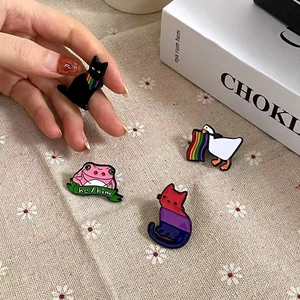 Cartoon enamel pin set with cat and goose designs featuring rainbow elements and pronouns