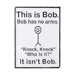 Close-up of a rectangular enamel pin with This Is Bob stick figure and text design