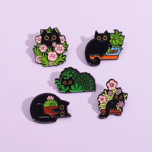 Set of five black cat enamel pins featuring floral, fish tank and garden scenes