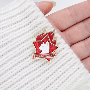 Soviet-style enamel brooch featuring a red star and white cat on a white sweater