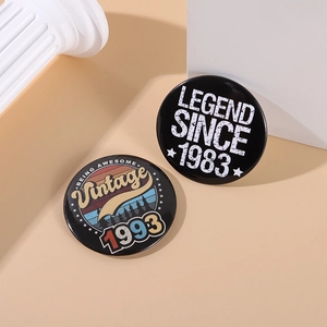 Retro tinplate badges with 1983 and 1993 vintage text on minimalist geometric props