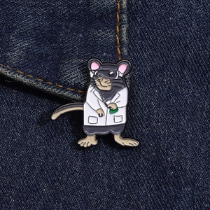 Close-up of a cartoon lab rat enamel pin on denim showing scientific details and texture