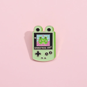 Cute green frog handheld game console enamel pin with Gamefrog Ribbit text design