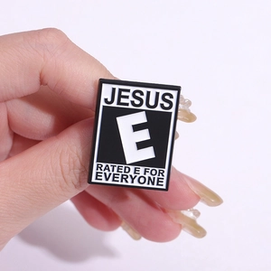 Macro detail of enamel pin showing Jesus Everyone rating and black finish