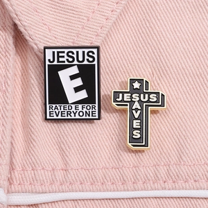 Detailed view of Jesus Rated E and Jesus Saves enamel pins on pink denim background