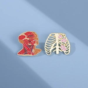 Detailed enamel pins set featuring anatomical head muscles and rib cage with pink flowers