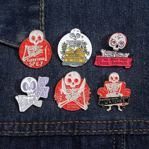 Set of 6 skeleton enamel pins with various themes on dark blue denim background