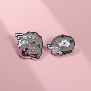 Detail of funny enamel opossum pins with I EXIST OUT OF SPITE and AWESOME POSSUM text