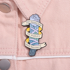 Close-up of creative enamel pin with sarcastic sage bundle design on pink denim jacket