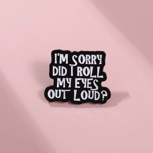 Detail view of black enamel brooch with I'M SORRY DID I ROLL MY EYES OUT LOUD text