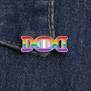 Rainbow DNA double helix enamel pin on denim jacket showing LGBTQ+ pride colors