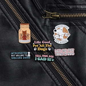Detail view of colorful enamel dog badges pinned on a black leather jacket texture