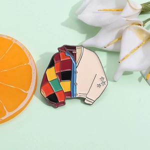 Colorful patchwork cardigan sweater enamel brooch pin with stars on a green background