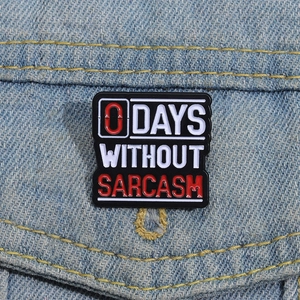 0 Days Without Sarcasm enamel pin brooch displayed on a blue denim jacket pocket