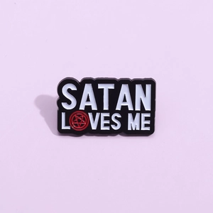 Black enamel Satan Loves Me pin with red pentagram and white lettering punk brooch