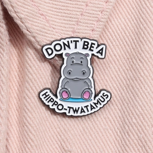 Cute cartoon hippo enamel metal brooch with Don't Be a Hippo-twatamus text on pink denim