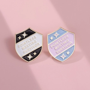 Macro detail of Pointless Meeting Survivor enamel pin badges on a soft pink background