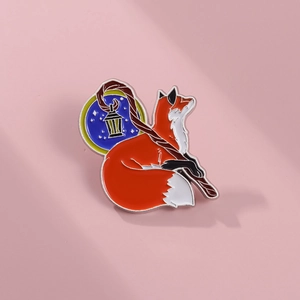 Detailed view of an orange fox enamel pin with a lantern staff on a purple background