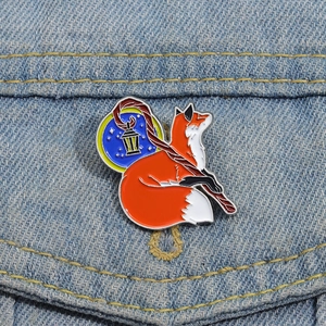 Detailed view of fox enamel pin with lantern on denim jacket showing vibrant craftsmanship