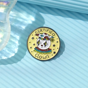 Detailed close-up of a colorful enamel clown pin badge with vibrant yellow background