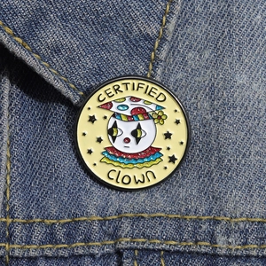 Cartoon clown enamel pin with Certified Clown text on denim jacket for clothing accessory