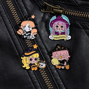 Close-up of four magical girl enamel pins pinned to a black leather jacket lapel