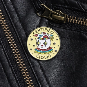 Detail of a round enamel clown pin with glitter accents and Certified Clown text