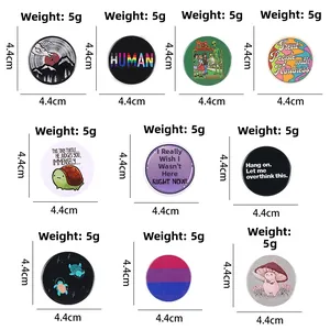 Detailed view of variety tinplate badges measuring 4.4cm with unique graphic patterns