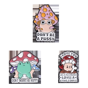 Detailed view of three enamel pins featuring cute cartoon mushrooms and frog with puns