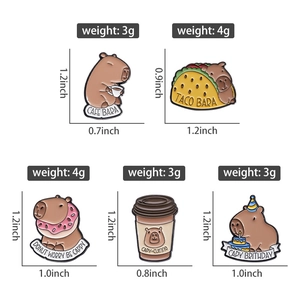 Detail showing five cute capybara enamel pins with food themes and size measurements