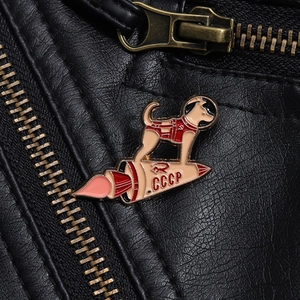 Detailed close-up of CCCP Laika space dog enamel pin on a black leather jacket