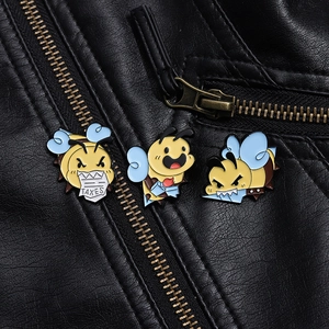 Set of three funny cartoon bee enamel pins with tax motif on black leather jacket