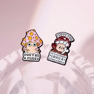 Detail of whimsical mushroom enamel pins on a clear glass rim with unique character art