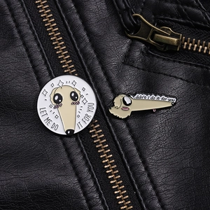 Close-up of enamel Borzoi long nose dog pins on a black leather jacket pocket