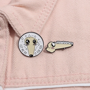 Detailed view of Long Nose Dog enamel pins on pink denim fabric with meme quotes