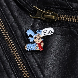 Detail shot of the Labyrinth blue worm enamel pin on a black leather jacket with Ello text