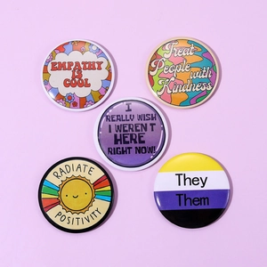Set of 5 colorful round tinplate badges with retro floral and empathy themed slogans