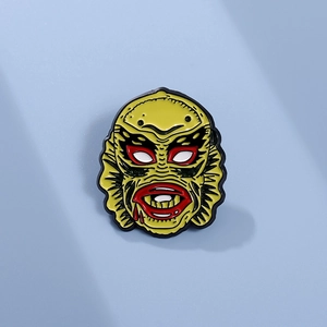 Quirky horror movie character enamel pin in bright yellow for Halloween costumes
