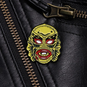 Classic yellow horror movie enamel pin on black leather background with vintage zipper