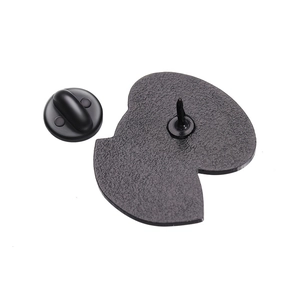 Macro detail of the matte metal brooch back with stable pin and black rubber clutch