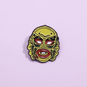 Cartoon monster enamel pin inspired by the Gill-man creature with vibrant yellow finish