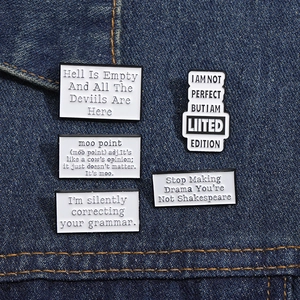 Detail showing five different text enamel pins on blue denim fabric with funny slogans