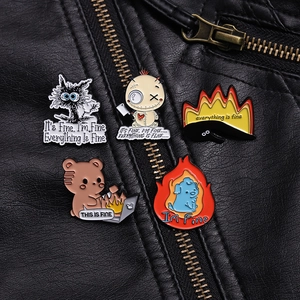 Detailed close-up of a five-piece enamel pin set pinned on a black leather jacket texture