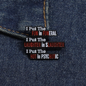 Macro shot of black enamel letter pin on denim fabric featuring humorous English slogan