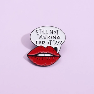 Artistic red lips enamel pin with 'STILL NOT ASKING FOR IT' quote on light purple background